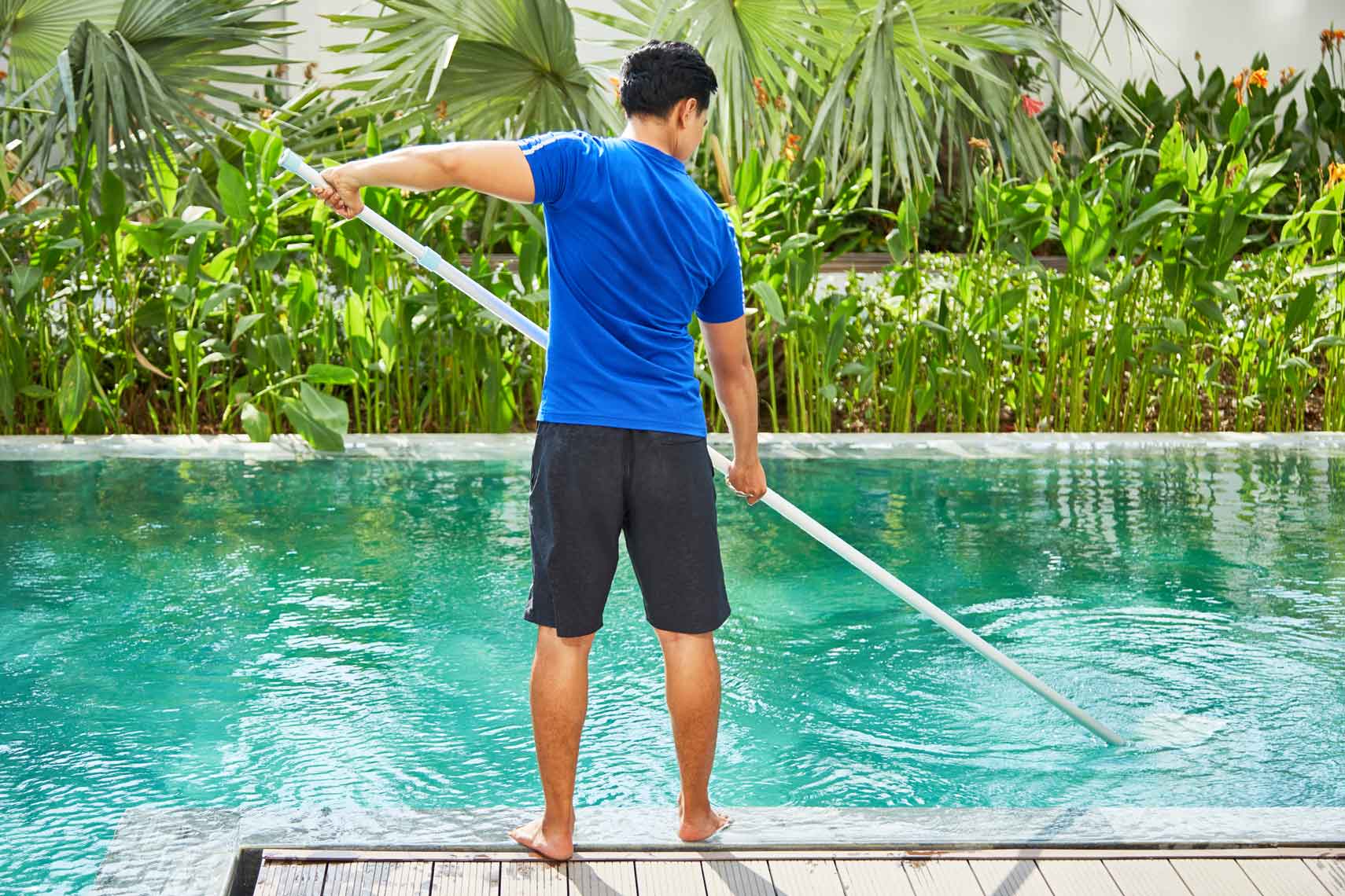 young-man-cleaning-pool-e1628821970333.jpg